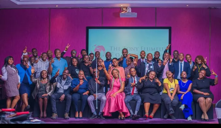 Group photo of participants on stage after a session
