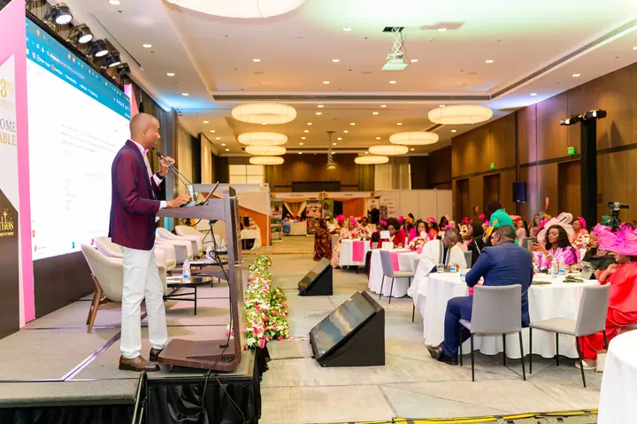 Cephas Gathii delivering a keynote to a full conference hall