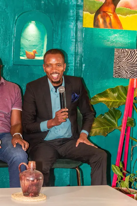Cephas holding a microphone during a panel discussion
