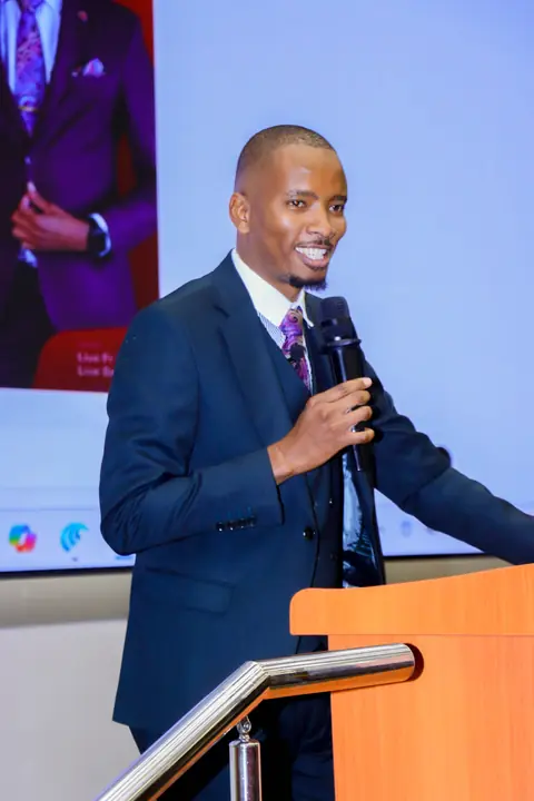Cephas presenting at a lectern during a corporate session