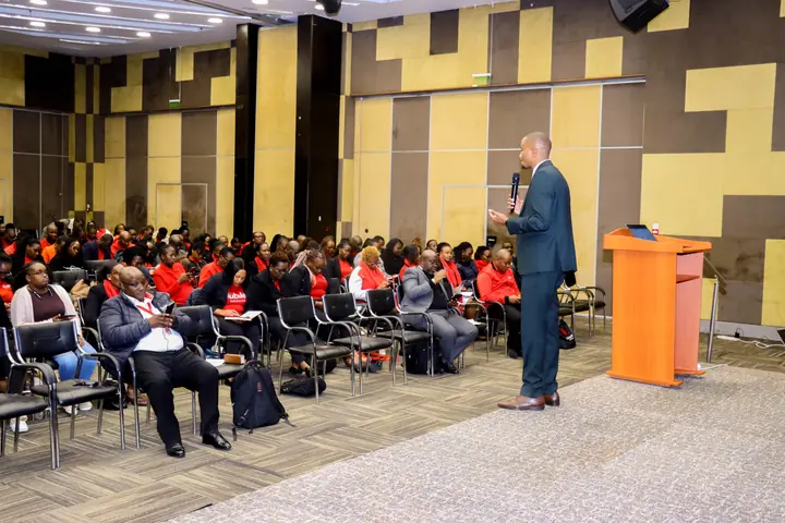 Cephas addressing a large audience during a corporate training session