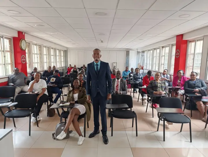 Cephas standing in a training room with participants