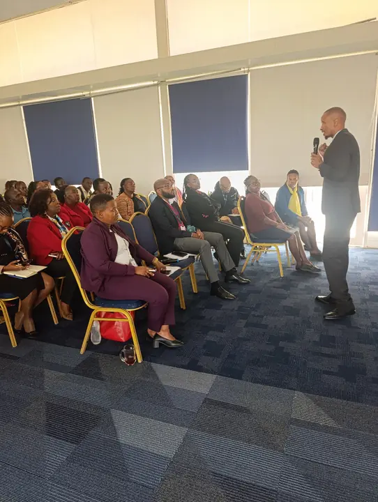 Cephas facilitating a session for a seated audience